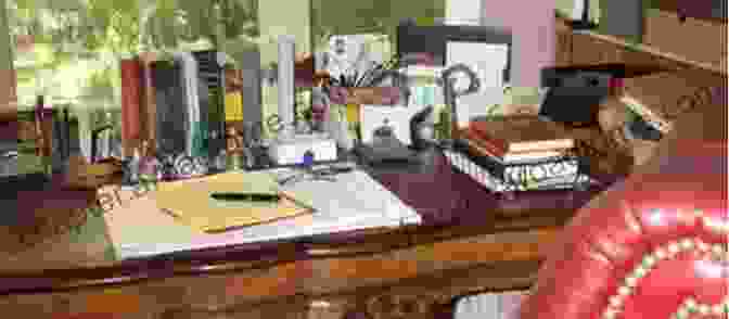 A Smiling Pat Conroy Sitting At A Desk, Surrounded By Books And Papers The Lost Prince: A Search For Pat Conroy